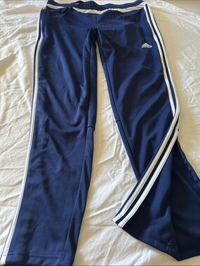 adidas Navy Blue women’s Track Pants with White Side Stripes and ankle zippers.